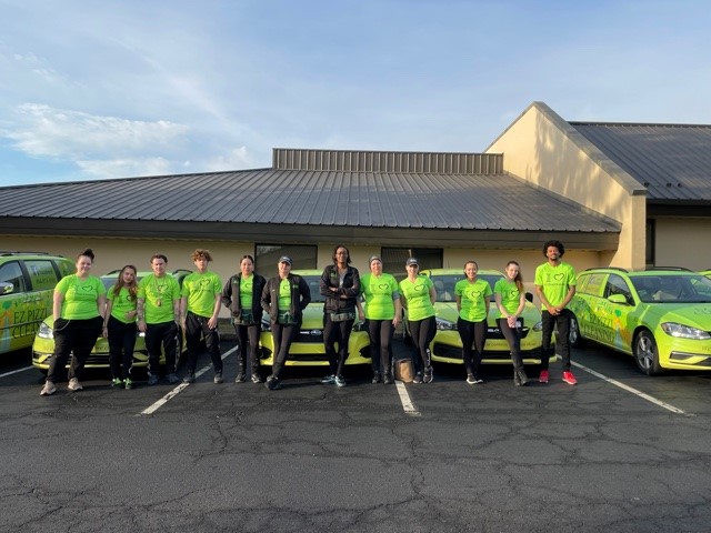 EZ Pizzi cleaning team outside the office building with the cleaning vehicles