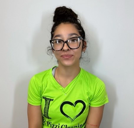A young woman wearing glasses and a green t - shirt.